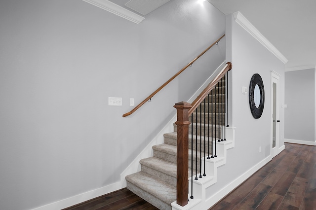 stairs featuring crown molding, baseboards, visible vents, and hardwood / wood-style floors