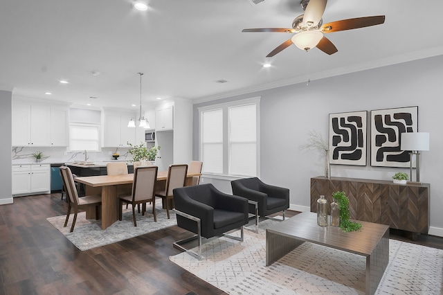 interior space with dark wood-style flooring, a ceiling fan, ornamental molding, and a wealth of natural light