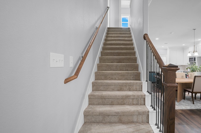 stairs featuring recessed lighting and wood finished floors