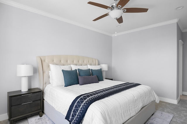carpeted bedroom featuring crown molding, baseboards, and ceiling fan