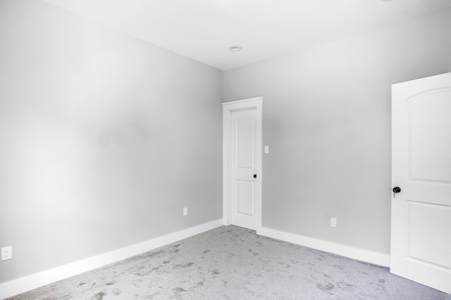 carpeted spare room with baseboards
