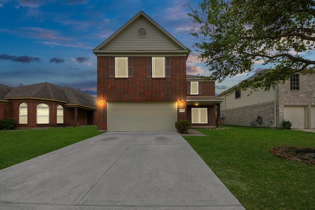 traditional home featuring a garage, brick siding, driveway, and a lawn