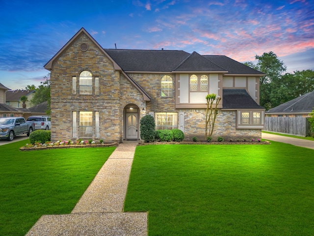 18211 Spellbrook Dr, Houston, TX 77084 - view of front of property with fence, brick siding, a front yard, and stucco siding