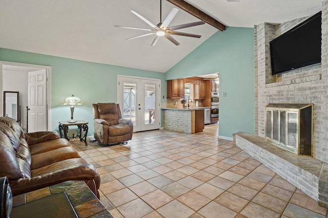 living room with french doors, a brick fireplace, beam ceiling, ceiling fan, and high vaulted ceiling