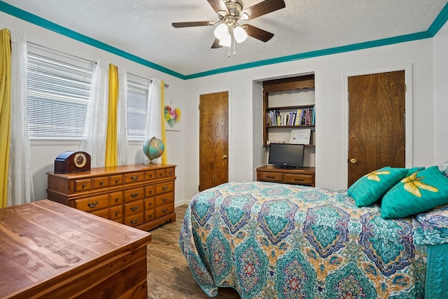 bedroom featuring a textured ceiling, two closets, and ceiling fan