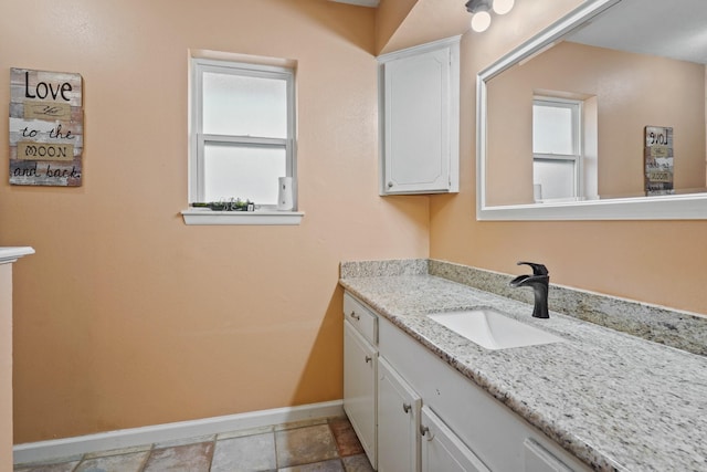 bathroom with baseboards and vanity