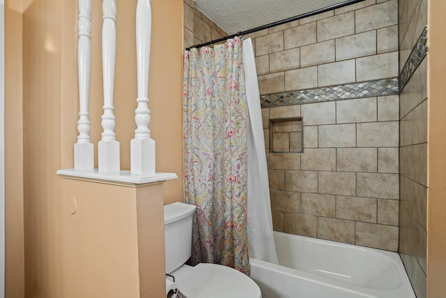 full bath featuring toilet, shower / bath combo with shower curtain, and a textured ceiling