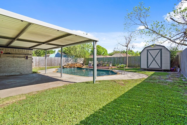 view of pool with a patio area, a fenced backyard, an outdoor structure, and a storage unit