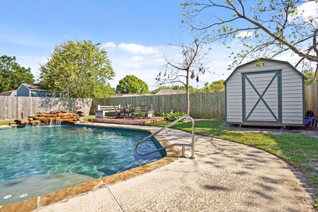 view of swimming pool featuring a storage shed, an outbuilding, and a fenced backyard