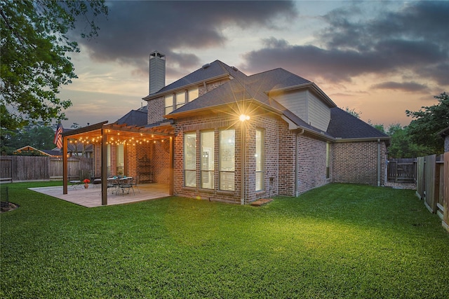 12203 Pinelands Park Ln, Humble, TX 77346 - back of house at dusk featuring brick siding, a pergola, a patio, a chimney, and roof with shingles