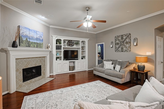 12203 Pinelands Park Ln, Humble, TX 77346 - living area with ceiling fan, wood finished floors, a tiled fireplace, and crown molding