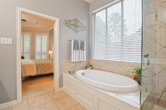12203 Pinelands Park Ln, Humble, TX 77346 - bathroom featuring a garden tub, healthy amount of natural light, tile patterned floors, ornamental molding, and ensuite bathroom