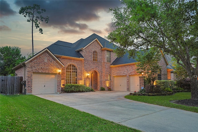 12203 Pinelands Park Ln, Humble, TX 77346 - view of front facade featuring brick siding, driveway, an attached garage, and a shingled roof