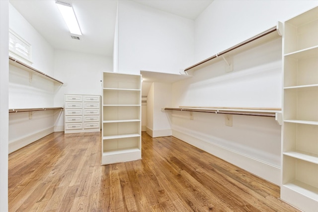 walk in closet with visible vents and wood finished floors