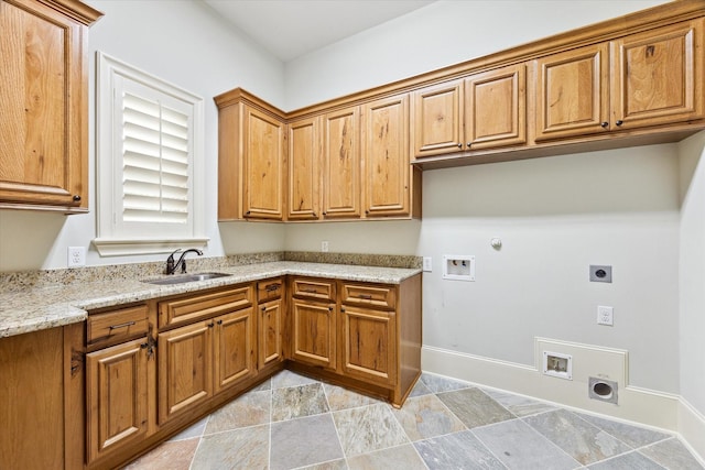 laundry area with hookup for a washing machine, cabinet space, hookup for an electric dryer, gas dryer hookup, and a sink