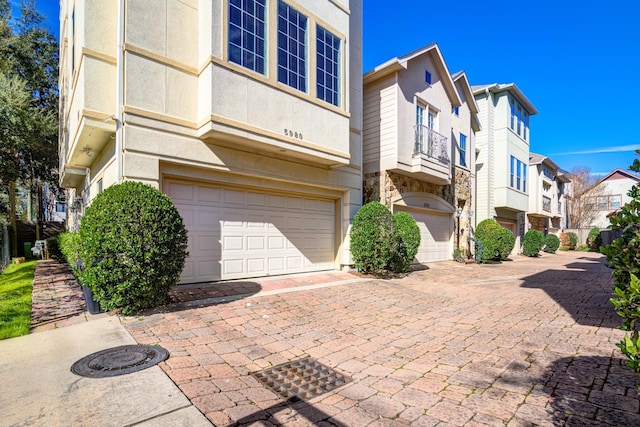 5976 Kansas St, Houston, TX 77007 - view of building exterior with a garage, a residential view, and decorative driveway