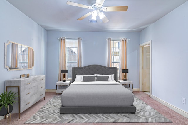 5976 Kansas St, Houston, TX 77007 - bedroom with light carpet, multiple windows, a ceiling fan, and baseboards