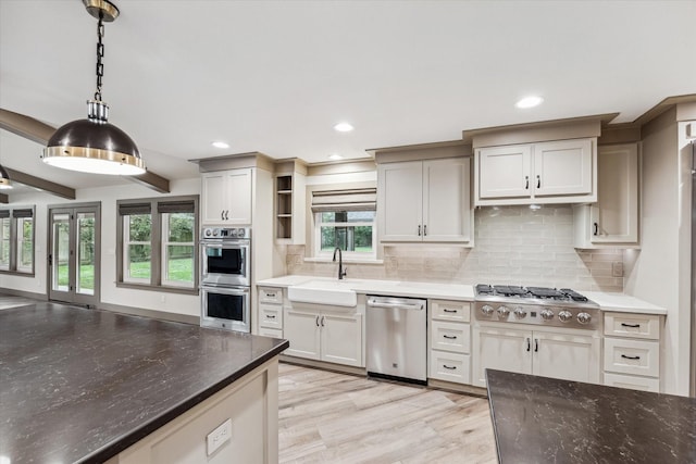 5807 Lilac St, Katy, TX 77493 - kitchen featuring hanging light fixtures, open shelves, a sink, stainless steel appliances, and backsplash
