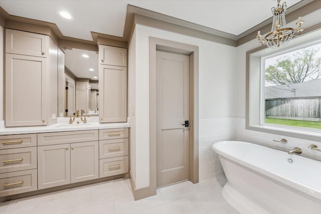 5807 Lilac St, Katy, TX 77493 - full bath featuring a freestanding bath, a notable chandelier, recessed lighting, vanity, and a wainscoted wall