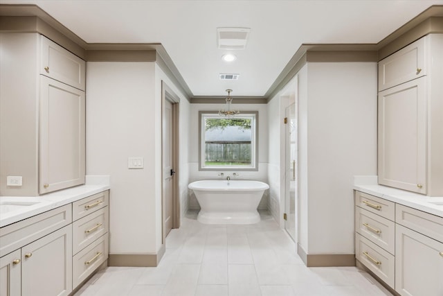 5807 Lilac St, Katy, TX 77493 - bathroom featuring visible vents, baseboards, ornamental molding, a soaking tub, and two vanities