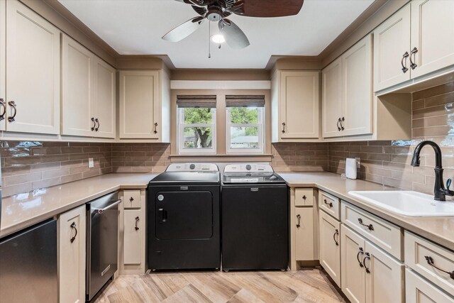 5807 Lilac St, Katy, TX 77493 - clothes washing area with cabinet space, light wood-type flooring, a ceiling fan, a sink, and washing machine and dryer
