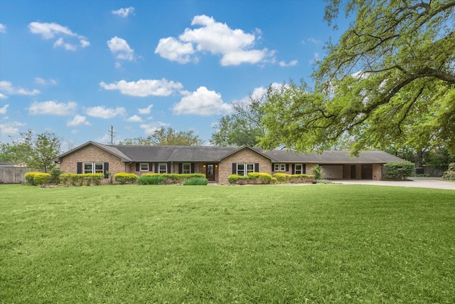 5807 Lilac St, Katy, TX 77493 - ranch-style house featuring a front lawn, fence, an attached carport, and driveway