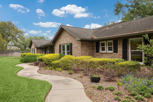 5807 Lilac St, Katy, TX 77493 - view of side of home with a shingled roof, a lawn, and brick siding