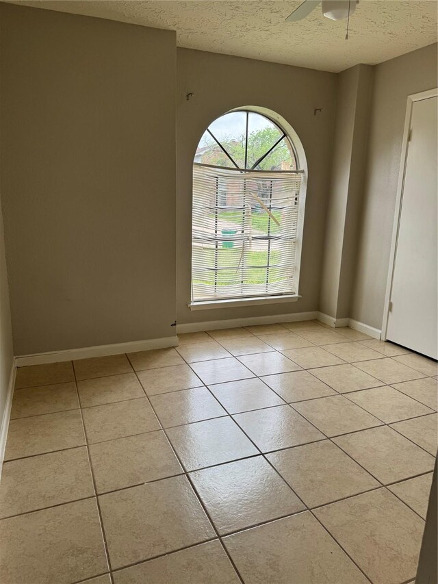 10726 Staghill Dr, Houston, TX 77064 - unfurnished room featuring light tile patterned floors, baseboards, and a textured ceiling