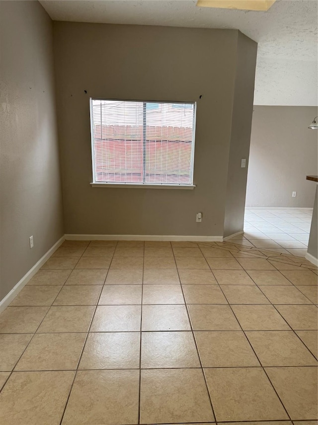 10726 Staghill Dr, Houston, TX 77064 - spare room with light tile patterned floors, baseboards, and a textured ceiling