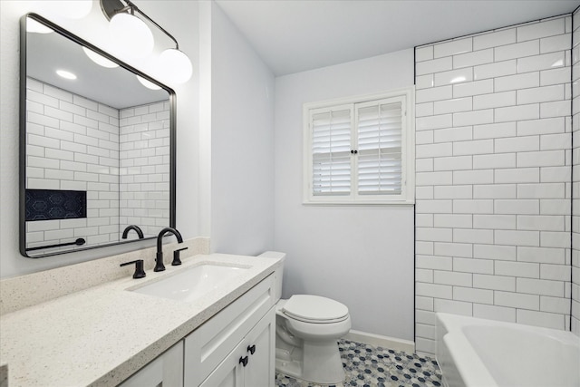 full bathroom featuring toilet, vanity, washtub / shower combination, and baseboards