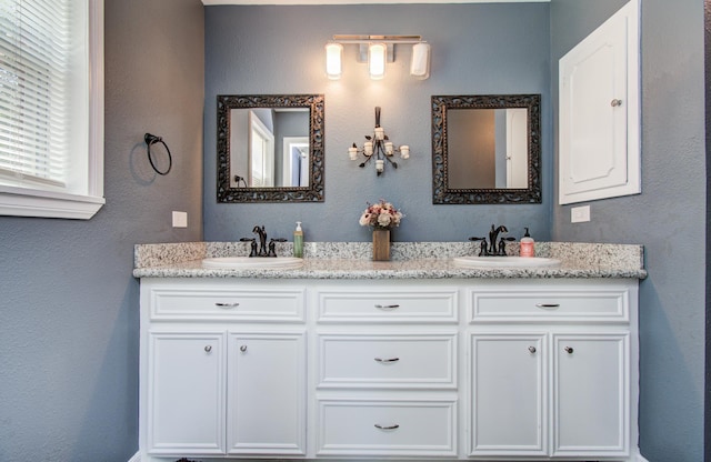 full bathroom featuring double vanity and a sink