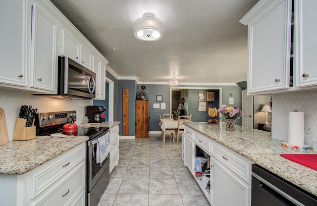 kitchen with crown molding, backsplash, stainless steel appliances, and white cabinetry