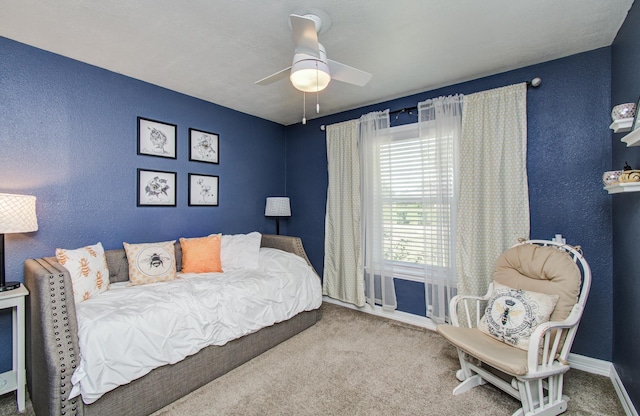 bedroom featuring baseboards, ceiling fan, carpet flooring, and a textured wall