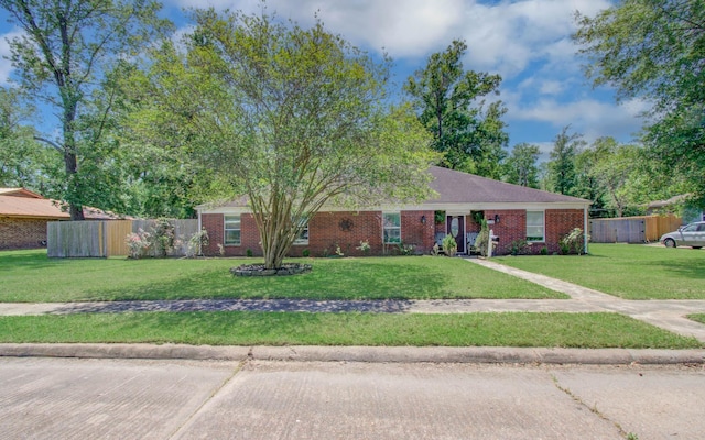 single story home with brick siding, fence, and a front yard