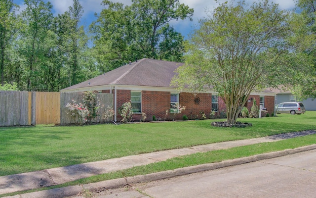 single story home with fence, a front yard, and brick siding