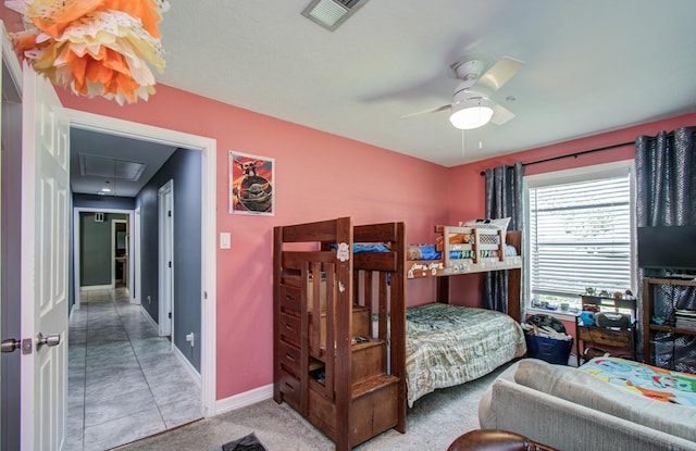 bedroom featuring baseboards, ceiling fan, attic access, and visible vents
