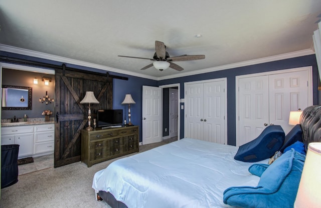 bedroom with crown molding, multiple closets, light carpet, ensuite bathroom, and a barn door