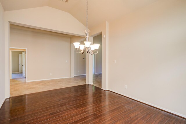 16007 Angler Bend Dr, Houston, TX 77044 - unfurnished dining area featuring baseboards, vaulted ceiling, an inviting chandelier, and wood finished floors