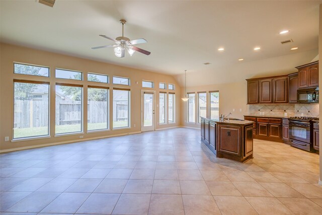 16007 Angler Bend Dr, Houston, TX 77044 - kitchen with tasteful backsplash, a sink, open floor plan, ceiling fan, and black appliances