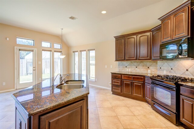 16007 Angler Bend Dr, Houston, TX 77044 - kitchen with visible vents, baseboards, a sink, black appliances, and decorative backsplash