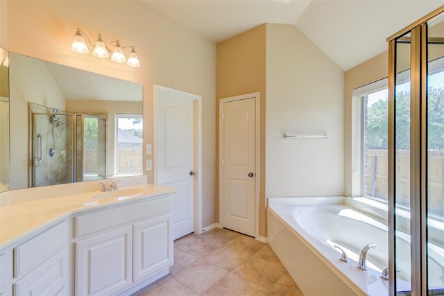 16007 Angler Bend Dr, Houston, TX 77044 - bathroom with lofted ceiling, a shower stall, vanity, tile patterned floors, and a garden tub