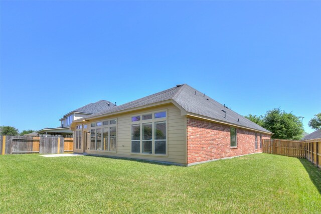 16007 Angler Bend Dr, Houston, TX 77044 - rear view of property with brick siding, a fenced backyard, a lawn, and roof with shingles