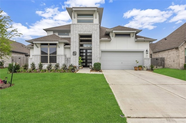 prairie-style home with a garage, a front lawn, brick siding, a shingled roof, and driveway