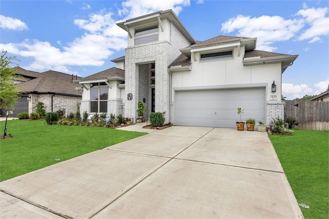 prairie-style home with an attached garage, fence, brick siding, a front lawn, and driveway