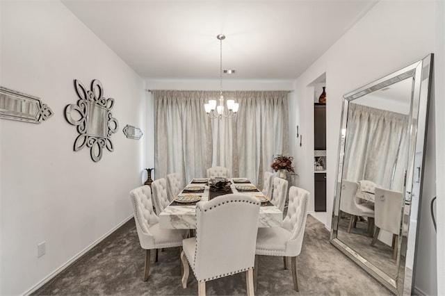 carpeted dining room featuring a notable chandelier and baseboards