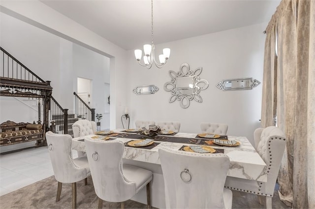 dining room featuring a chandelier and stairs