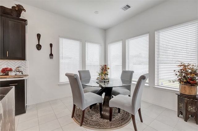 dining space with visible vents, baseboards, and light tile patterned flooring