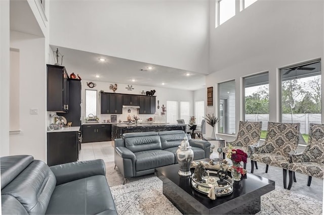 living area with recessed lighting and a towering ceiling
