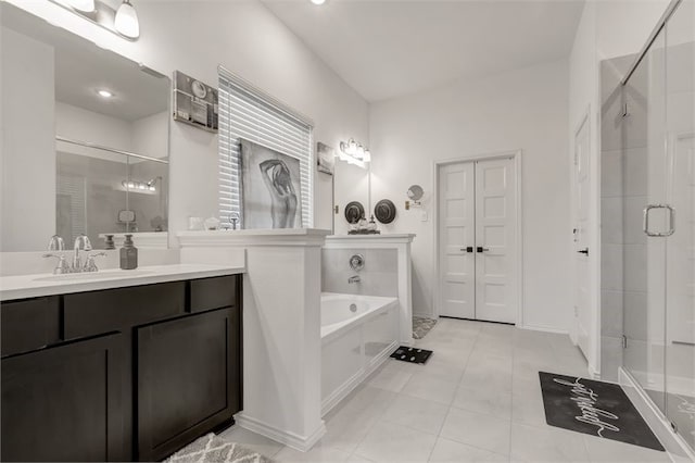 full bathroom featuring tile patterned flooring, a bath, a shower stall, and vanity