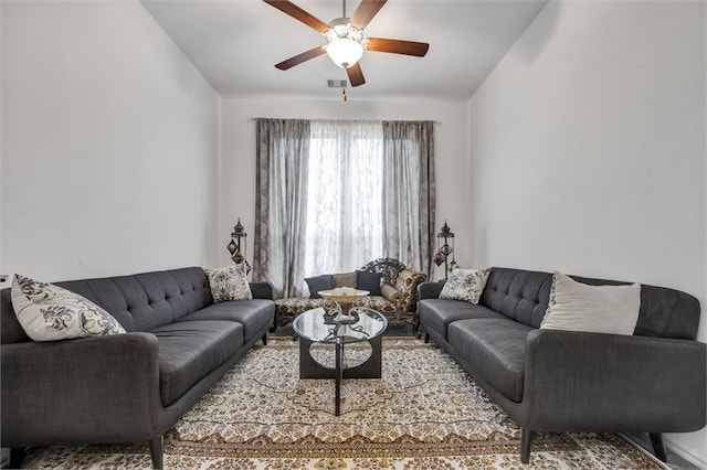 living room with visible vents, ceiling fan, and lofted ceiling
